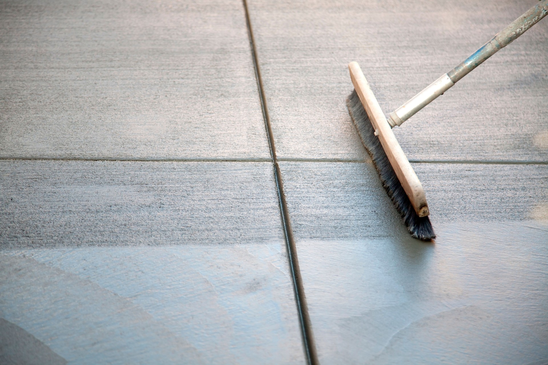 A concrete patio with brush on top